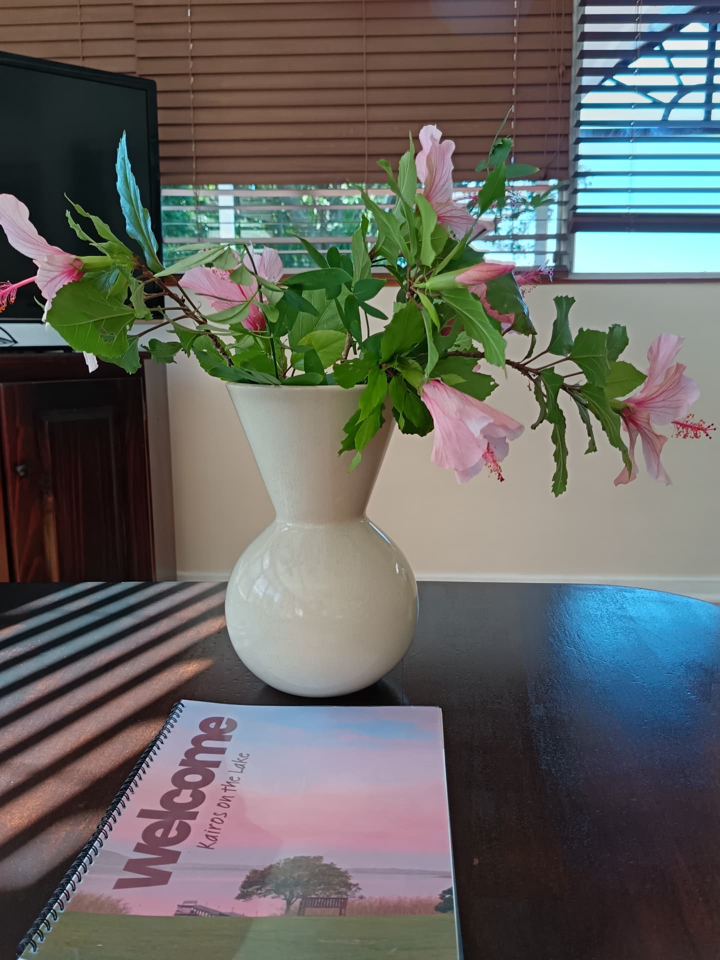 Welcome book and fresh hibiscus flowers inside a chalet
