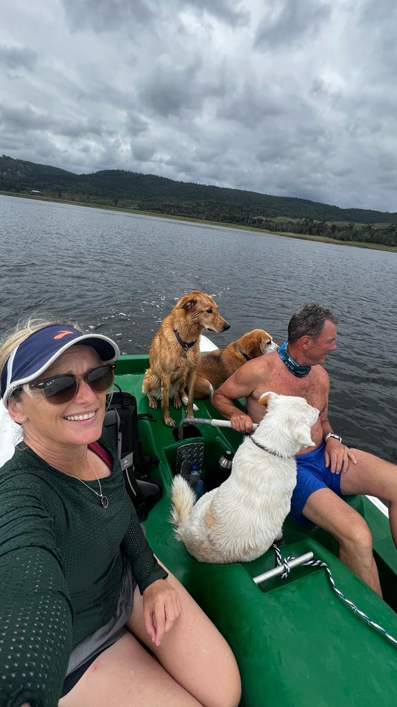 Guests and dogs out on the lake in a boat