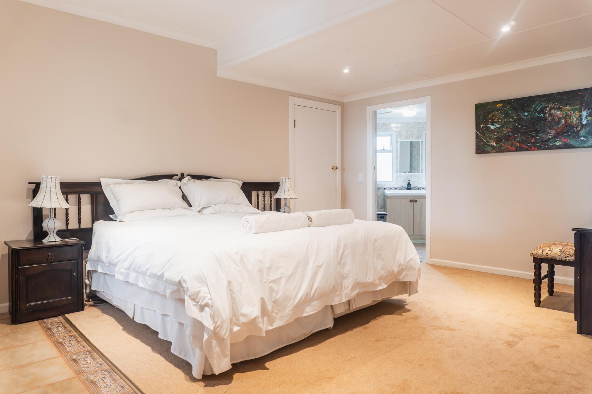 King-size bedroom with en-suite bathroom at Sunbird Chalet