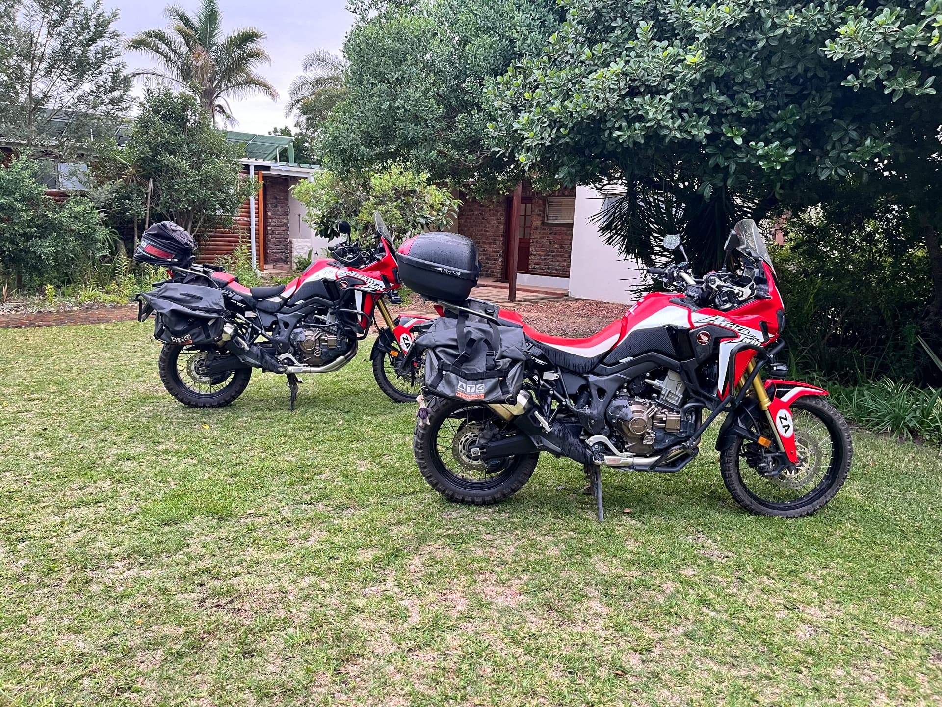 Adventure motorbikes parked on the garden lawn at the chalets