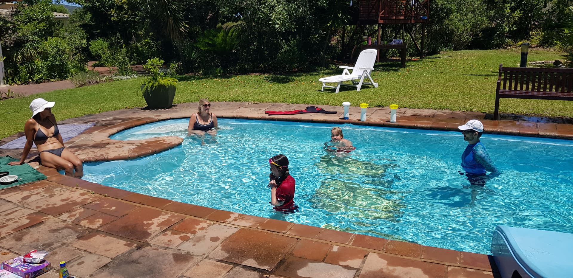 Family enjoying the estate swimming pool on a summer day