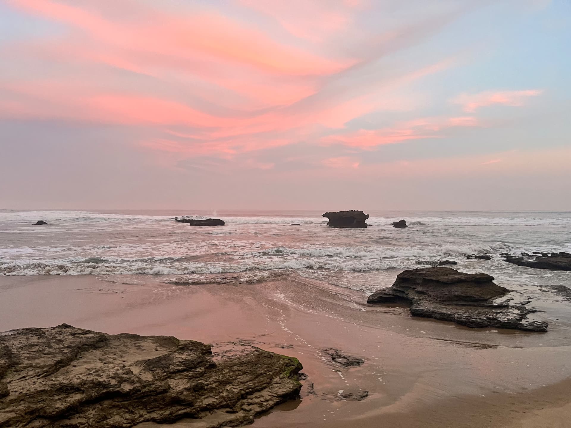 Pink sunset over rocky Garden Route beach near Sedgefield