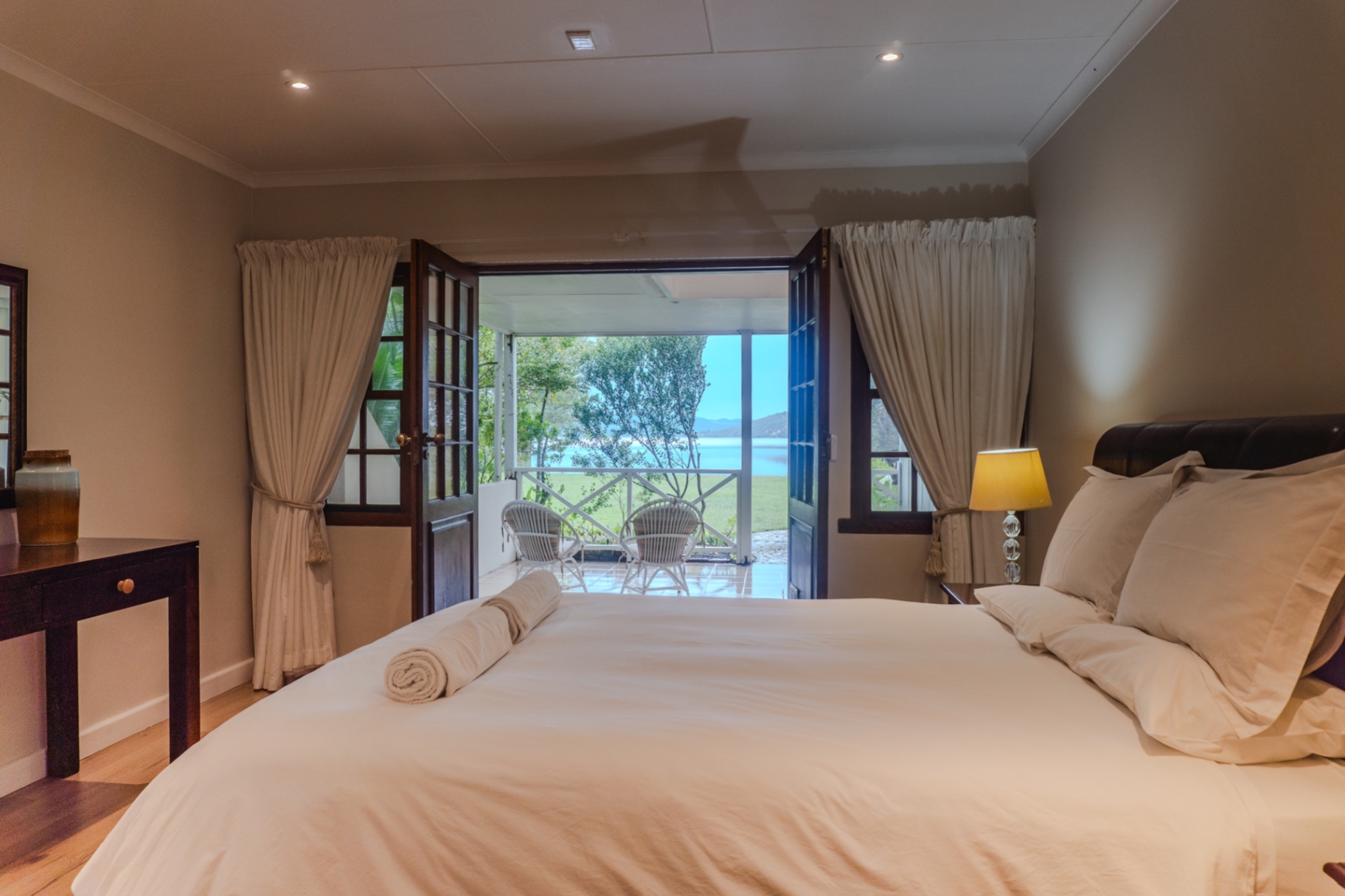 King bedroom opening onto the lake-view patio
