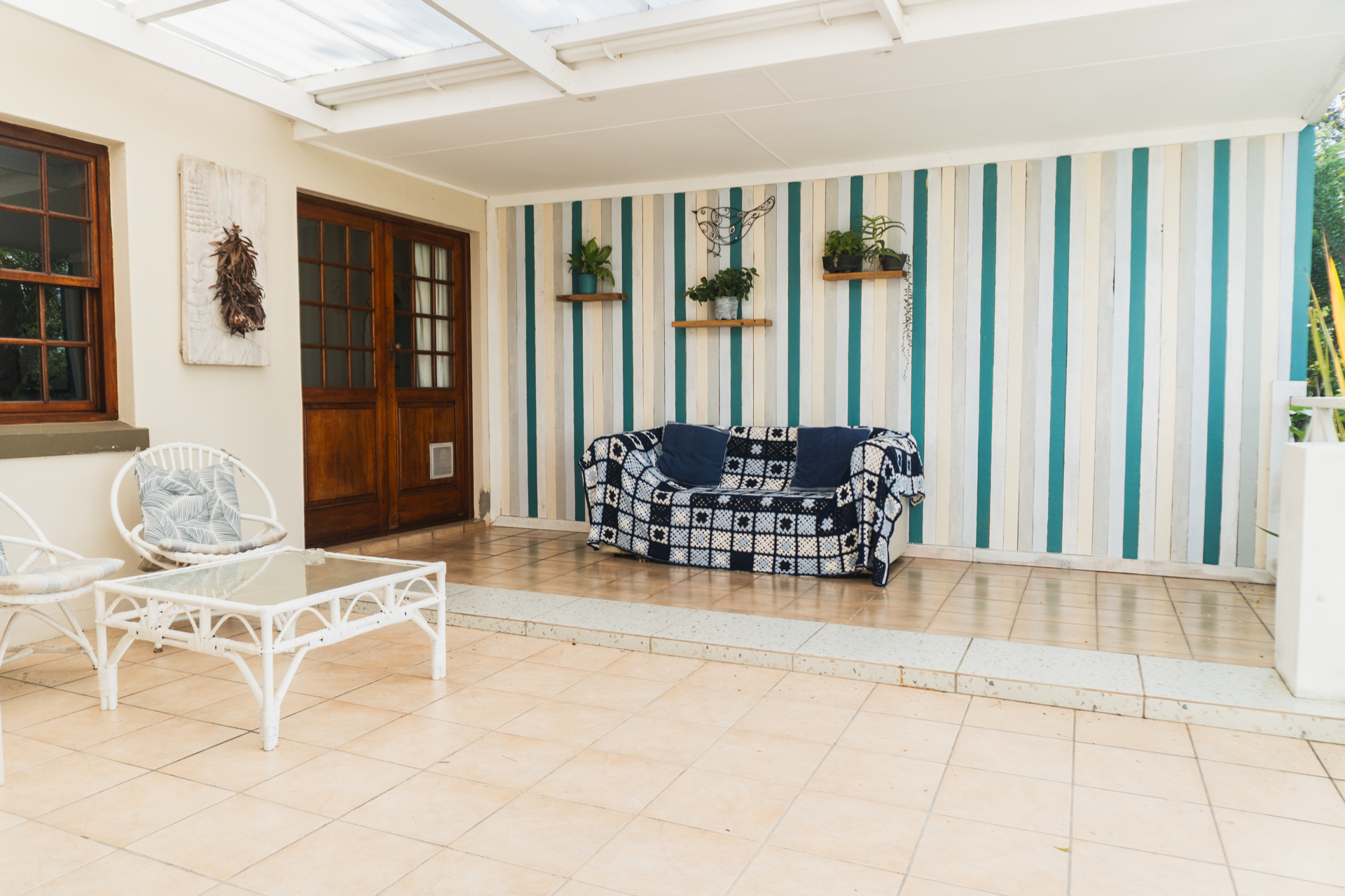 Covered patio entrance with seating at Sunbird Chalet