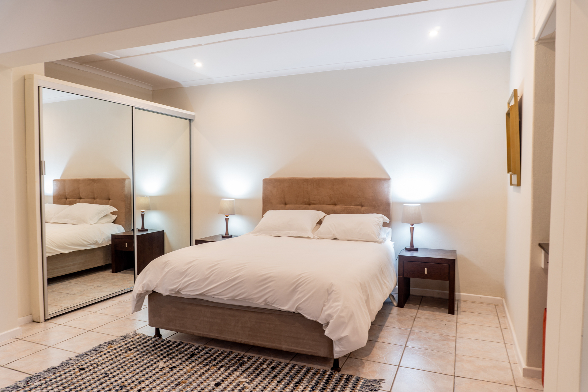 Spacious double bedroom with workspace at Loerie Chalet